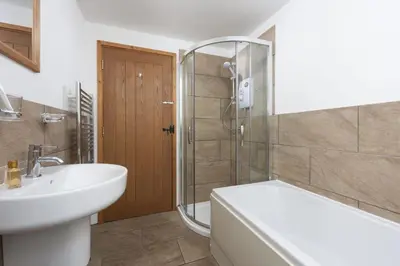 a bathroom with a sink and a tub and a shower at Hot Tub Bungalow - Close to Portreath - Free WiFi - Free Parking - Pet Friendly in Redruth