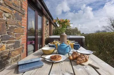 a wooden table with food on top of it at Hot Tub Bungalow - Close to Portreath - Free WiFi - Free Parking - Pet Friendly in Redruth