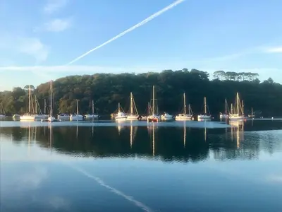 a group of boats sitting in the water at The Lake House , luxury rural retreat in Ladock