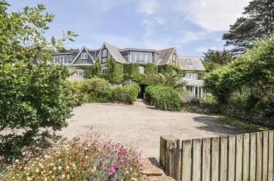 an exterior view of a large house with a fence at Bodare 8 in Wadebridge