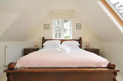 a bedroom with a bed with two towels on it at Bodare 8 in Wadebridge