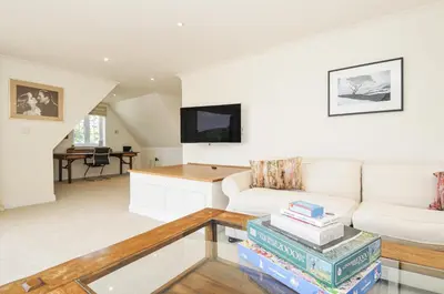 a living room with a white couch and a table at Bodare 8 in Wadebridge