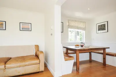 a living room with a table and a couch at Bodare 8 in Wadebridge