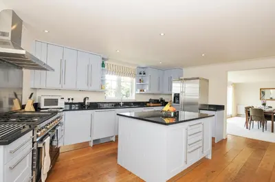 a kitchen with white cabinets and a counter top at Bodare 8 in Wadebridge