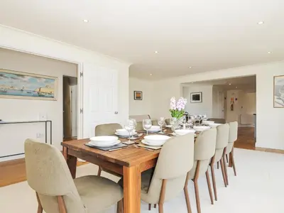 a dining room with a wooden table and chairs at Bodare 8 in Wadebridge