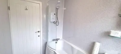 a bathroom with a shower and a toilet in it at Cornerways, Nr Perranporth in Perranzabuloe