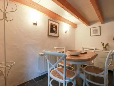 a dining room with a wooden table and chairs at 2 Rose Cottage in St. Agnes