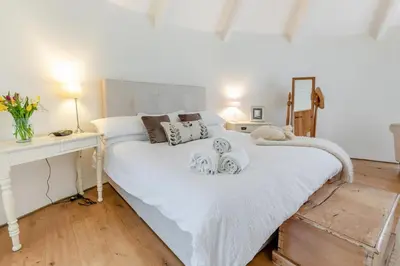 a bedroom with a large white bed with towels on it at 3 Bed in Gwennap oc-g30876 in Gwennap