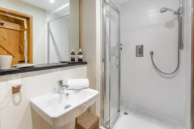 a white bathroom with a sink and a shower at 3 Bed in Gwennap oc-g30876 in Gwennap