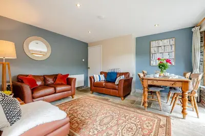 a living room with leather furniture and a table at 2 Bed in Little Petherick oc-o30788 in Little Petherick
