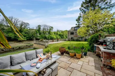 a patio with a couch and a table in a yard at 1 Bed in Little Petherick oc-a30789 in Little Petherick