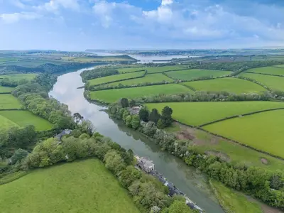 an aerial view of a river with green fields at 1 Bed in Little Petherick oc-a30789 in Little Petherick