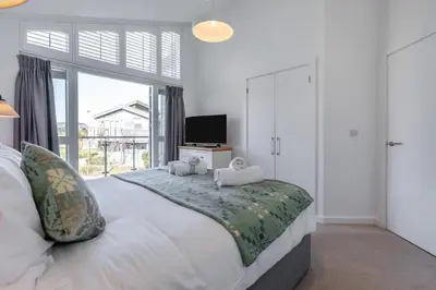 a bedroom with a large bed with a television on it at 4 Bed in Lelant oc-a30881 in Carbis Bay