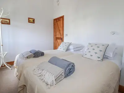 a bedroom with two beds with towels on them at The Hayloft in St Austell