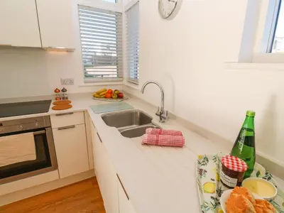 a kitchen with a sink and a counter top at Una, Lodge 77 in St Ives