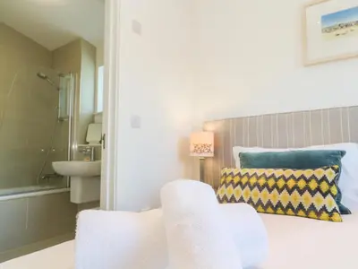 a bathroom with a bed and a sink at Una, Lodge 77 in St Ives