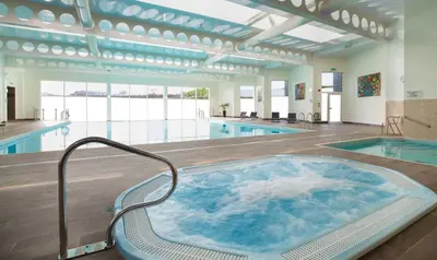 a hot tub in the middle of a swimming pool at 55 Una in Carbis Bay