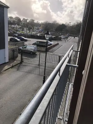 a balcony with a view of a parking lot at Captains Rest - Contemporary 4 bed apartment in Falmouth