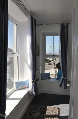 a room with a window with a view of an airport at Gordon House B & B in Tintagel