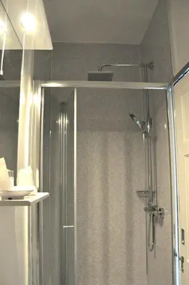 a bathroom with a shower with a shower curtain at Gordon House B & B in Tintagel