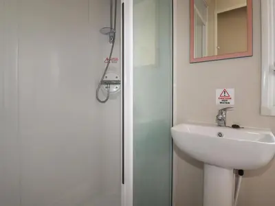 a bathroom with a sink and a shower at 82 Hillside in Newquay