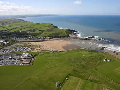 an aerial view of a golf course and the ocean at Rosebud Beach Hut in Otterham