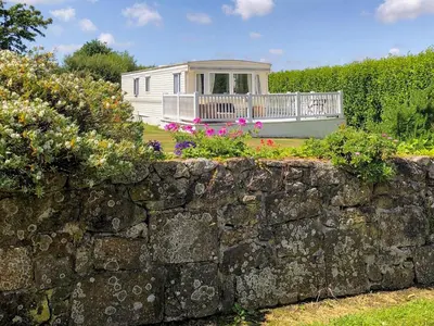 a stone wall in front of a house at Demelzas Retreat in Redruth