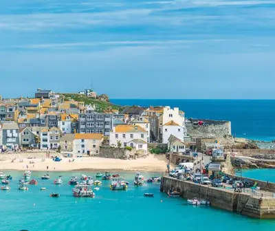 a group of boats in the water near a beach at 11 longstone house St ives carbis bay in Carbis Bay