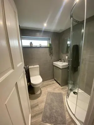 a bathroom with a toilet and a shower and a sink at The Porthole in Port Isaac