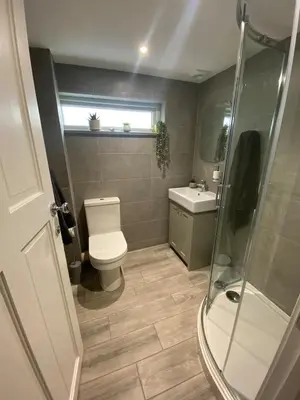 a bathroom with a toilet and a sink and a shower at The Porthole in Port Isaac