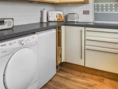 a kitchen with a dishwasher and a counter top at The Hideaway - Spacious 3 Bedroom Apartment in Truro
