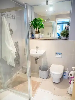 a bathroom with a shower and a toilet and a sink at Headland Hideaway, Fistral Beach Newquay, Cornwall in Newquay