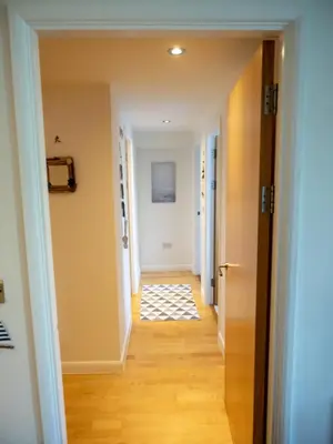 a hallway in a house with a hallway leading into a room at Atlantic Hideaway, Fistral Beach, Newquay Cornwall in Newquay