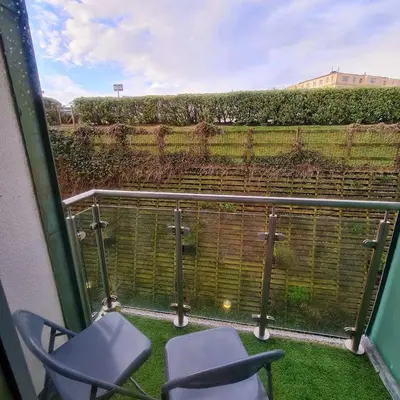 a balcony with two chairs and a fence at Atlantic Hideaway, Fistral Beach, Newquay Cornwall in Newquay