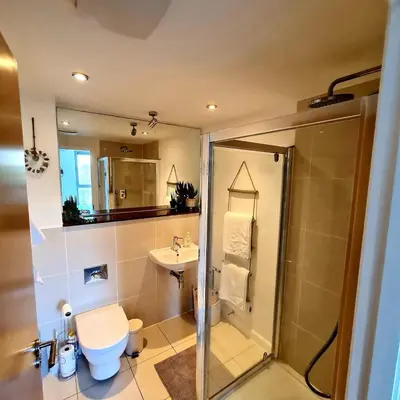 a bathroom with a shower and a toilet and a sink at Atlantic Hideaway, Fistral Beach, Newquay Cornwall in Newquay