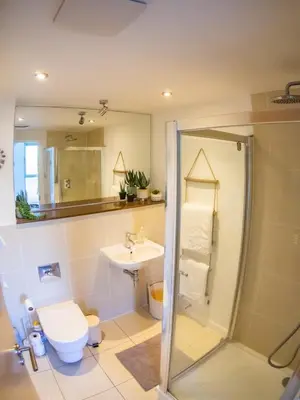 a bathroom with a shower and a toilet and a sink at Atlantic Hideaway, Fistral Beach, Newquay Cornwall in Newquay