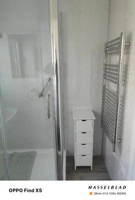 a bathroom with a shower and a sink and a white cabinet at Tolroy manor holiday cottage in Saint Erth