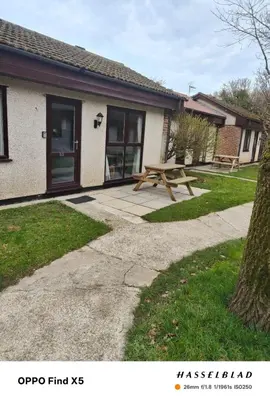 a picnic table in front of a house at Tolroy manor holiday cottage in Saint Erth