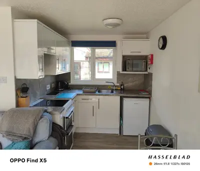 a kitchen with white cabinets and a sink at Tolroy manor holiday cottage in Saint Erth