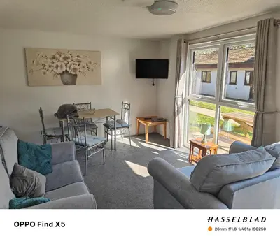 a living room with a couch and a table and chairs at Tolroy manor holiday cottage in Saint Erth