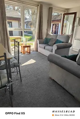 a living room with two couches and a table at Tolroy manor holiday cottage in Saint Erth