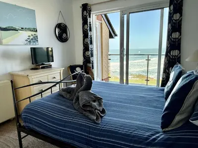 a bedroom with a bed with a towel on it at 16 Waters Edge, Atlantic Breezes in Newquay