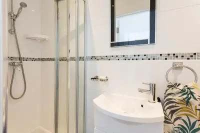 a bathroom with a shower and a sink at Pendunes - Spectacular views, turquoise sea, love Cornwall in St Ives