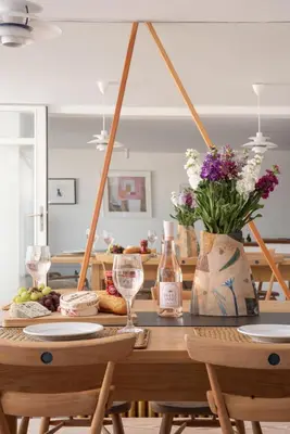a dining room table with wine glasses and flowers at 11 Piazza in St Ives