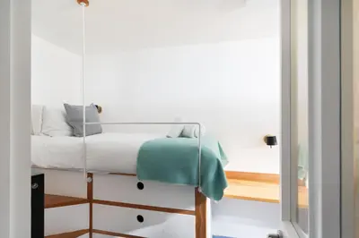 a bedroom with a swing bed in a room at 11 Piazza in St Ives