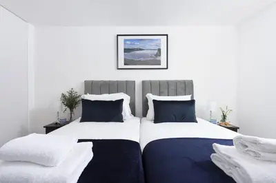 two beds sitting next to each other in a bedroom at 1 Island Reach in Newquay