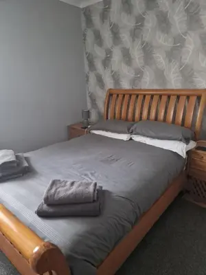 a bedroom with a bed with two towels on it at cornish Choughs Inn in Camborne