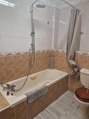 a bathroom with a tub and a toilet at cornish Choughs Inn in Camborne