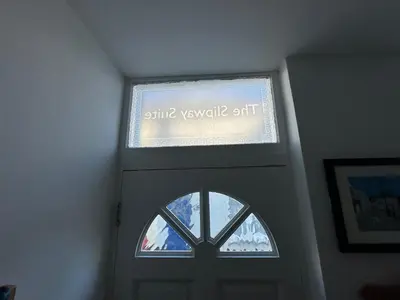 a window above a door with a sign on it at The Slipway Suite Fowey Harbour & Parking 1 Min in Fowey