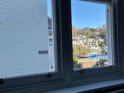 a window with a view of a harbor at The Slipway Suite Fowey Harbour & Parking 1 Min in Fowey